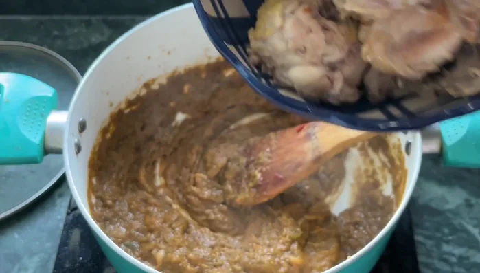 Add the seared chicken to the pot and mix well.
