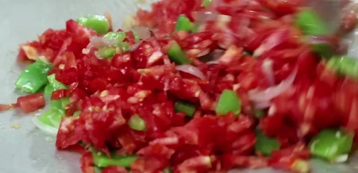 Add tomatoes, coriander leaves, pav bhaji masala, salt, and green chilies. Cook until tomatoes are soft.