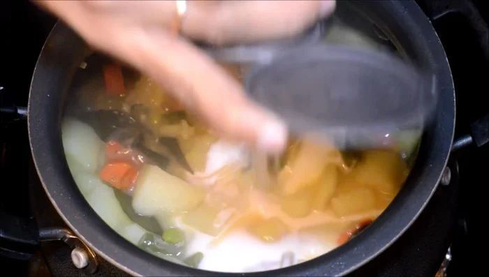 Add thick coconut milk, mix well, and bring to a boil. Then, remove from heat.