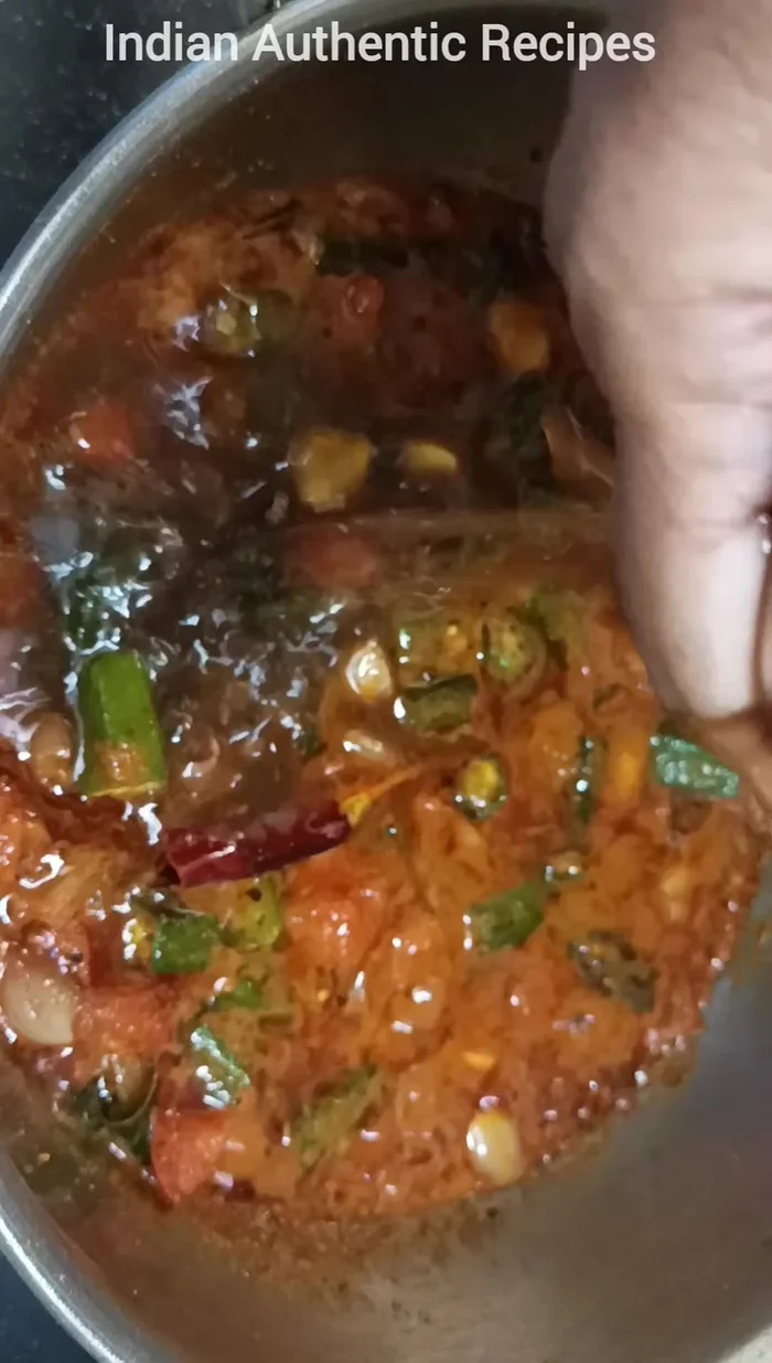 Add the soaked and dissolved tamarind. Adjust water consistency as needed.