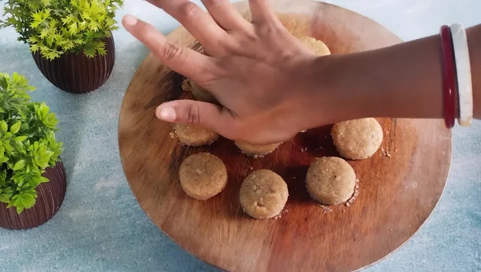 Gently press the biscuits to make them uniform in size and thickness. You can add a design if desired.