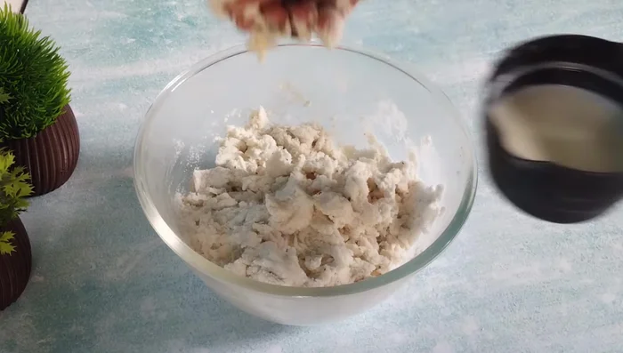 Gradually add hot milk (or water), mixing with your hands until a smooth dough forms. Let it rest for 30 minutes.