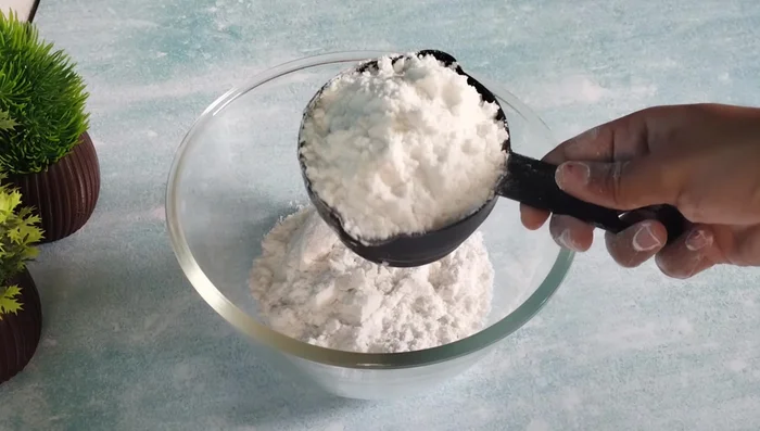 Mix rice flour, refined flour, desiccated coconut, and salt in a bowl.
