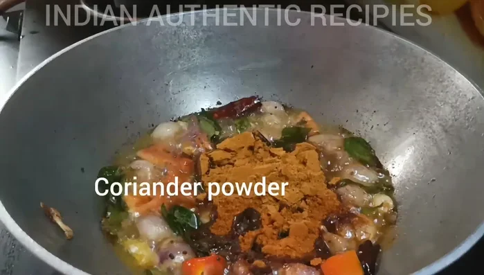 Sauté onions, tomatoes, and curry leaves in oil until softened. (This step is inferred and needs further details from the video)