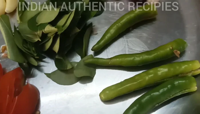 Prepare the spice paste. This likely involves grinding together ginger, garlic, green chilies, and spices. (This step is inferred and needs further details from the video).
