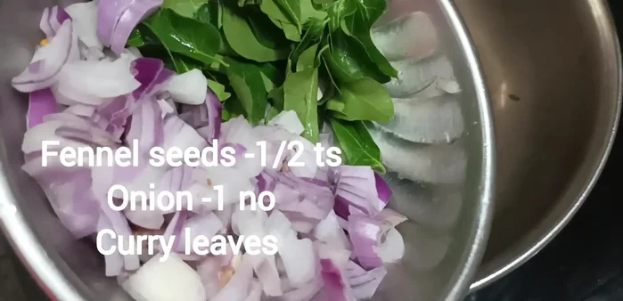 In a separate pan, heat 5 tbsp of peanut oil, add anise, then onion, and curry leaves. Saute well.