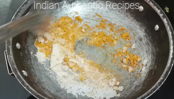 Add turmeric powder, salt, and stir well.