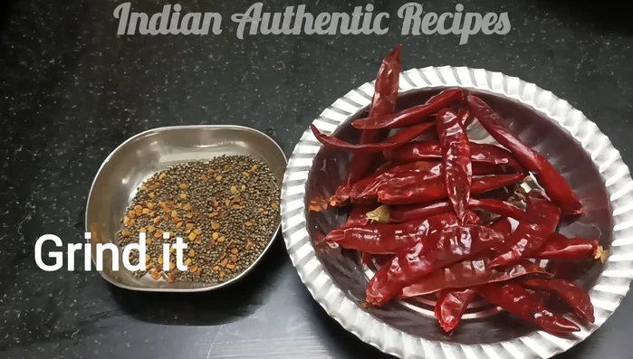 Grind the roasted garlic, mustard seeds, fenugreek seeds, and chilies separately.