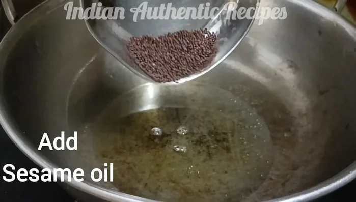 Add a little more oil, mustard seeds, and turmeric powder. Add the roasted chili powder and mix well.