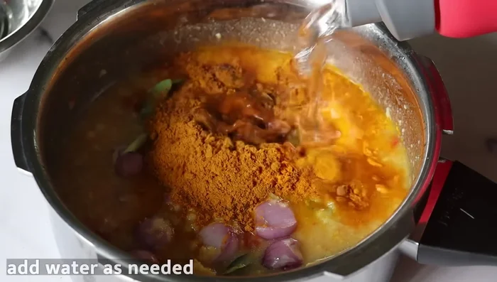 Add the moong dal and tamarind pulp.