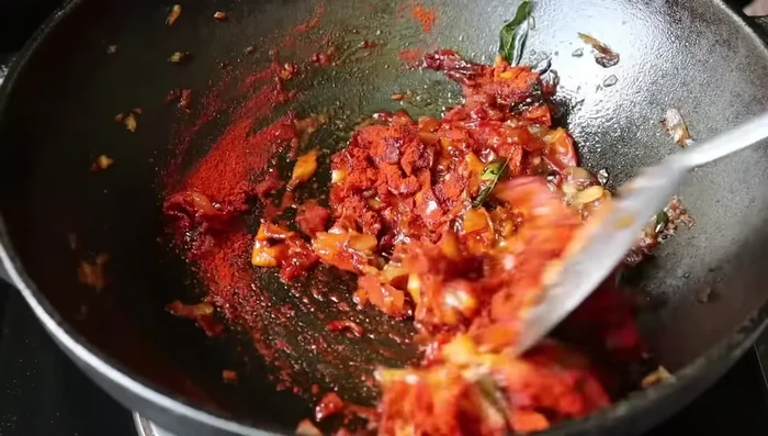 Add turmeric powder and chili powder. Mix well.