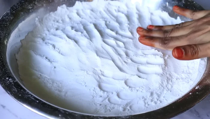 Carefully place the flattened dough into the heated pan. Ensure that they are not overcrowded.
