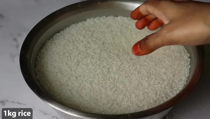 Combine rice flour, jaggery, ghee, and cardamom in a large mixing bowl.