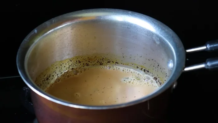 Adding milk and sugar (likely)