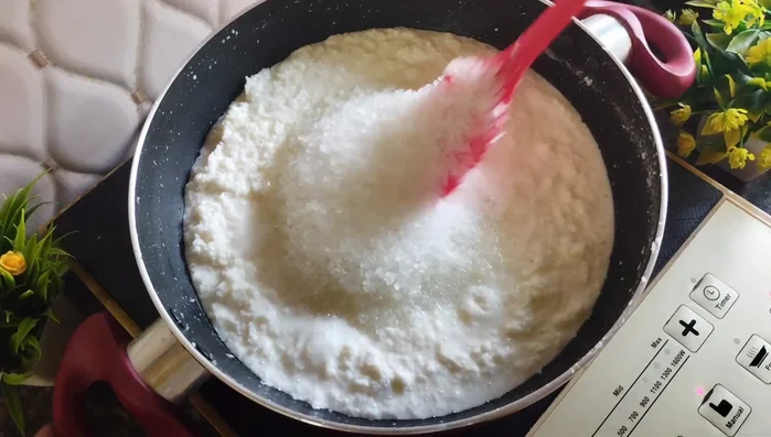 Add 1 cup of sugar (or jaggery) and stir until the sugar melts and the mixture becomes liquid again.