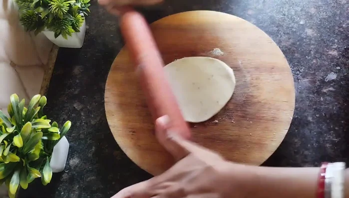 Roll out the dough balls: Sprinkle some dry flour on a surface to prevent sticking. Roll out each ball into a thin, large circle (like a puri).