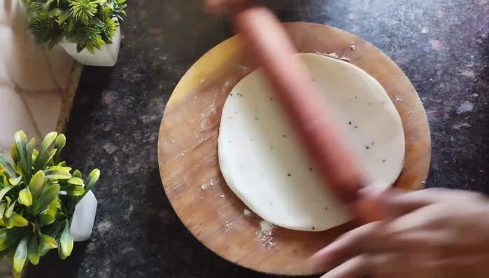 Roll and cook: Gently roll out the layered dough into a large, thin circle. Lightly heat a large pan and cook the rolled dough on low heat, flipping it to cook both sides until tiny bubbles appear (don’t overcook).