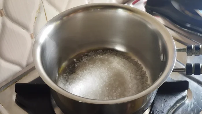 Prepare the syrup: In a saucepan, combine sugar, water, and crushed cardamom. Cook over low heat until sugar dissolves and the syrup boils. Turn off the heat and set aside.