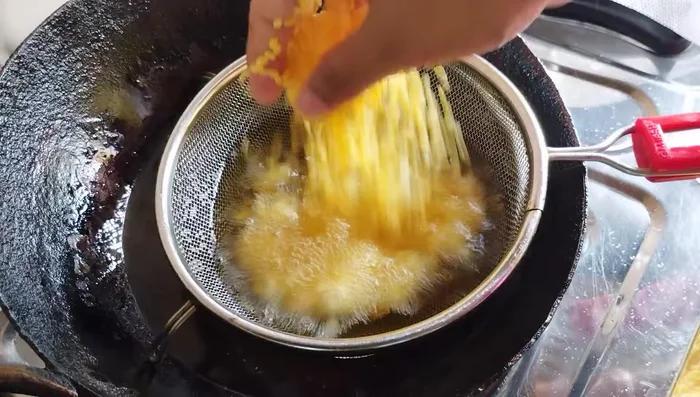 Remove the fried moong dal and place it on a tissue-lined plate to drain excess oil.