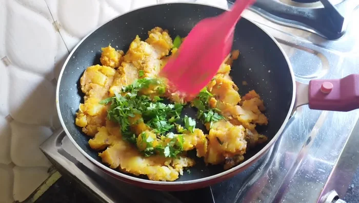 Add chopped coriander leaves and fry until well roasted (96.68).