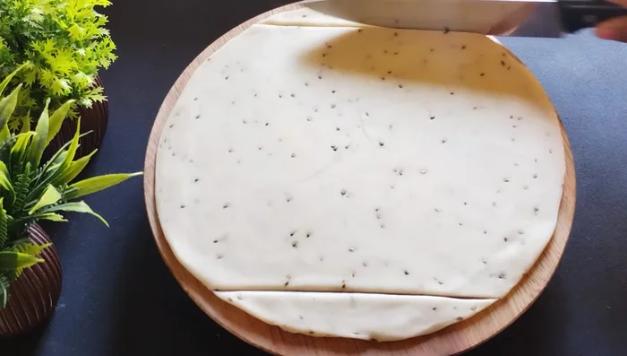 Cut the rolled dough into squares. Cut each square into smaller squares (432.479).