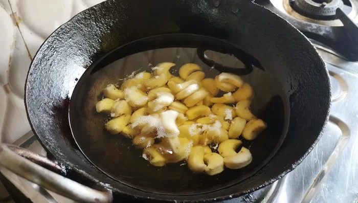 Fry until golden brown and crispy, ensuring they puff up nicely. Avoid high heat which may burn them before they are cooked through.