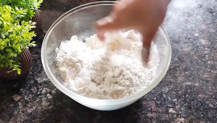 Add oil (or ghee) and rub it into the flour until the mixture resembles breadcrumbs.
