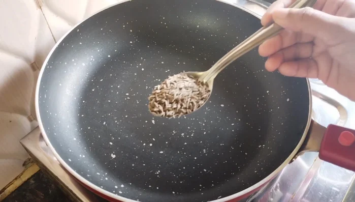 Prepare the masala: Roast cumin seeds, coriander, sesame seeds, asafoetida, and dry coconut in a pan on low flame. Let it cool, then mix with Kashmiri red chili powder, turmeric powder, roasted cumin powder, salt, and sugar (optional). Grind coarsely in a mixer.