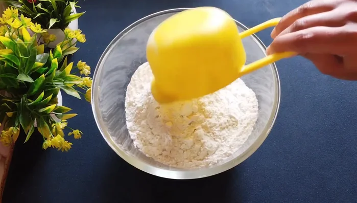 Prepare the dough: In a bowl, mix refined flour, gram flour, celery, and salt. Add oil and rub well until it binds. Gradually add water to make a hard dough. Cover and let it rest for half an hour.