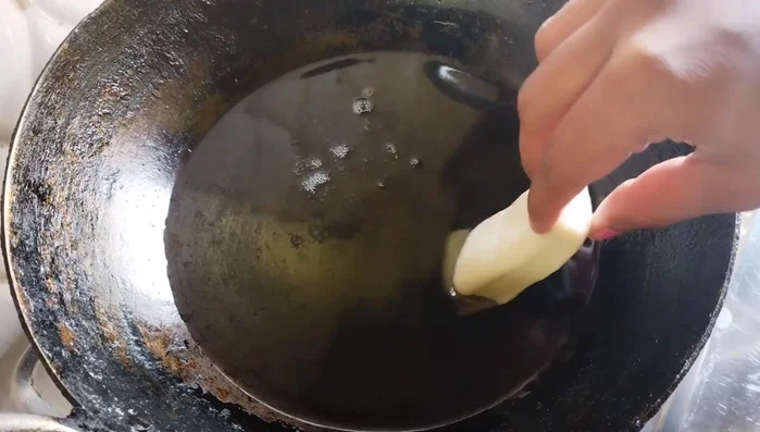 Heat oil in a pan. Fry the Goja pieces over low heat, turning occasionally, until they are golden brown and puffed up. This takes approximately 7-8 minutes per batch.