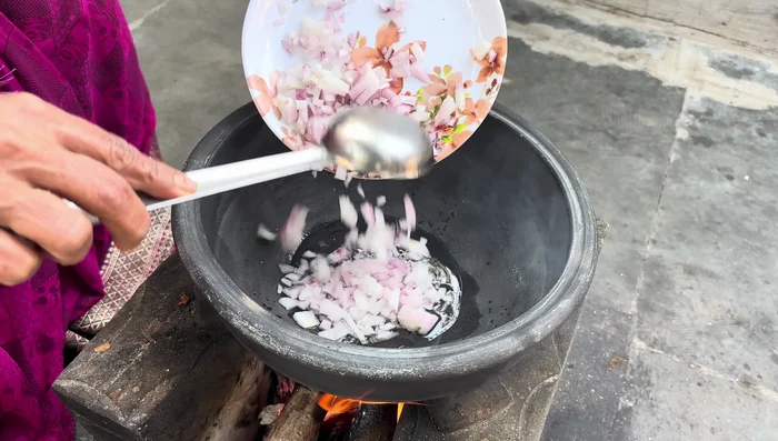 Heat oil in a pan and sauté the chopped onions until golden brown.