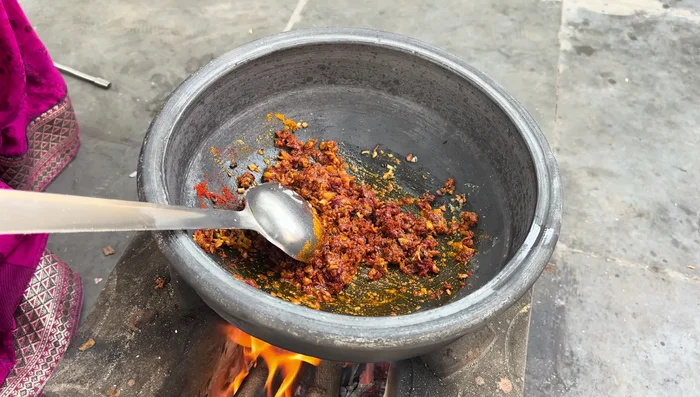 Add the marinated chicken to the pan and cook, allowing it to release its own water.