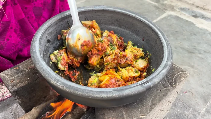 Add hot water to the pan and simmer until the chicken is cooked thoroughly.