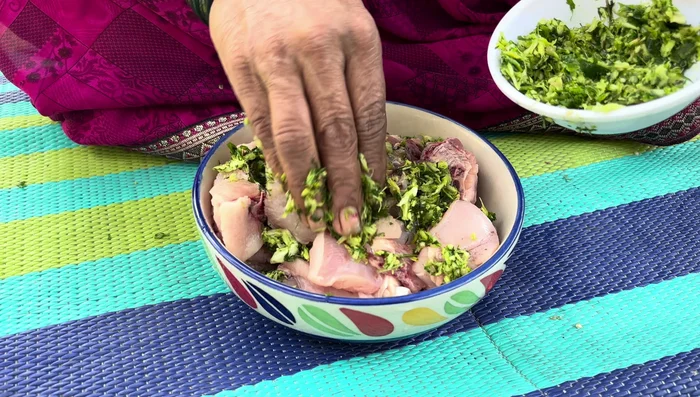 Apply the paste generously to the chicken, rubbing it well to ensure even coating. Add turmeric powder and salt to taste.