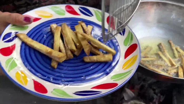 Remove the fried chips from the oil and let them cool slightly.
