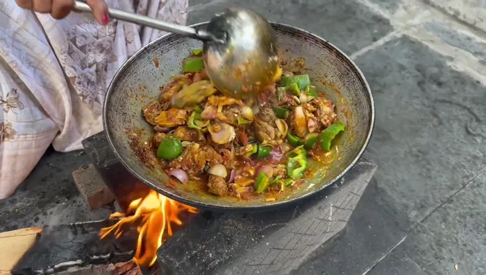 Add onions and capsicum, cover, and steam again.