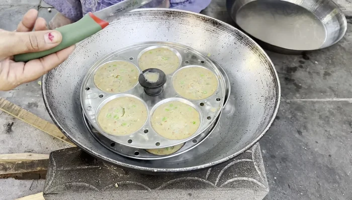 Check for doneness: Insert a toothpick or skewer into the idlis; if it comes out clean, they are cooked.