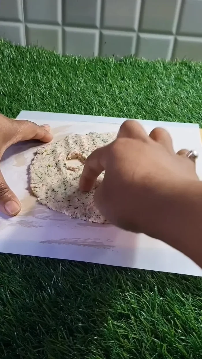 Make four holes in the center of the dough.