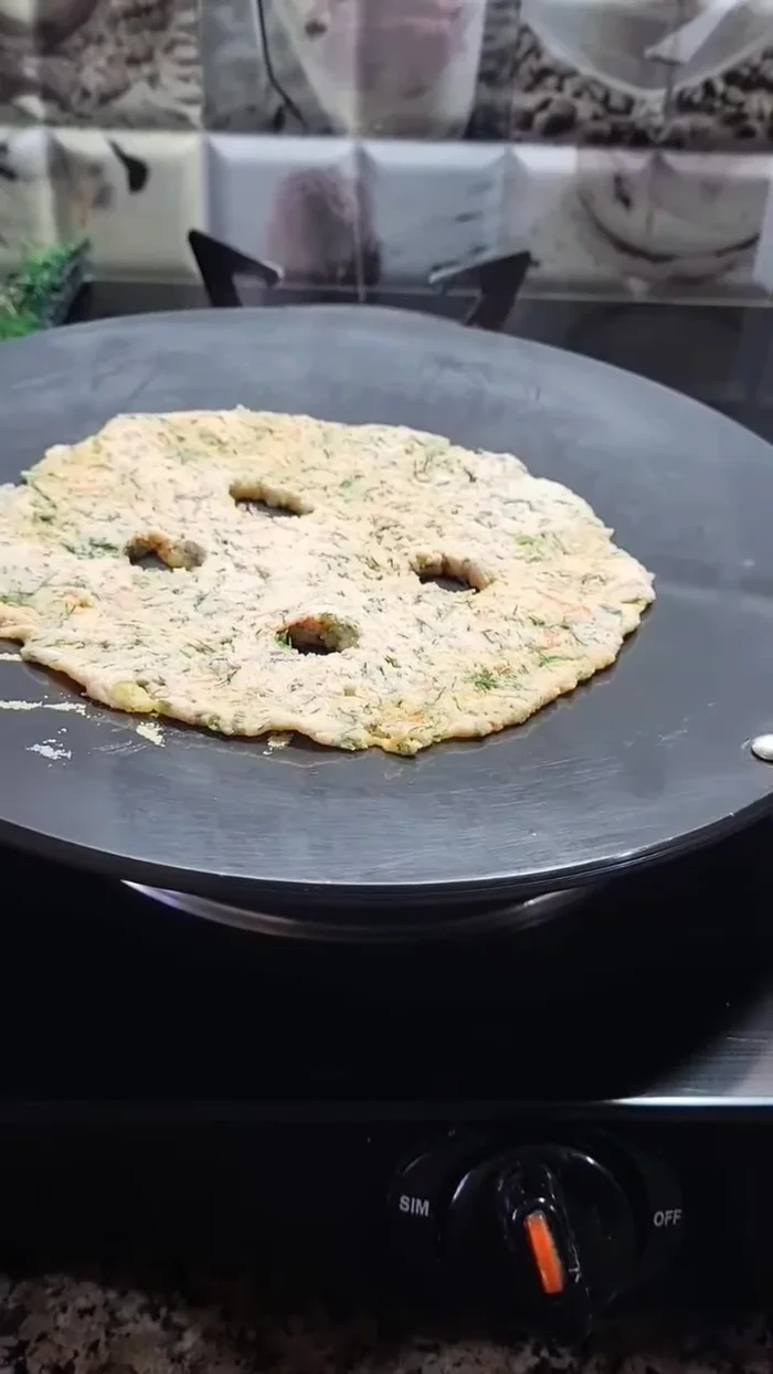 Cook the roti on the pan, removing the butter paper after one minute. Add a little oil and fry until golden brown and crispy.