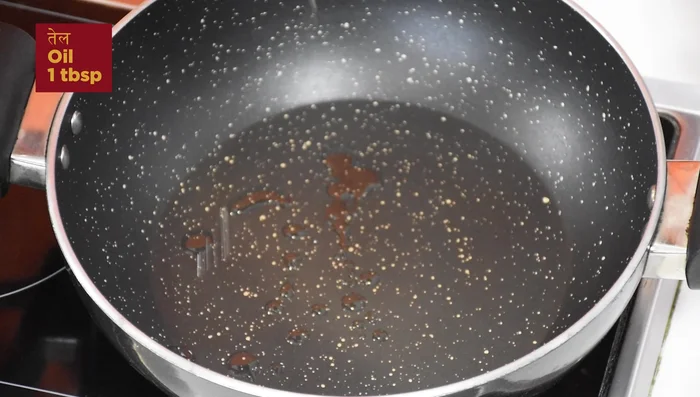Prepare the tadka: Heat oil and butter in a pan. Add asafoetida, cumin seeds, and garlic. Fry until fragrant.