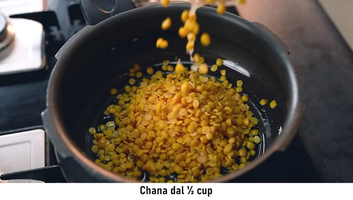 Wash and fry arhar dal and gram dal in ghee until golden brown. Some prefer mustard oil, but ghee yields a better flavor.