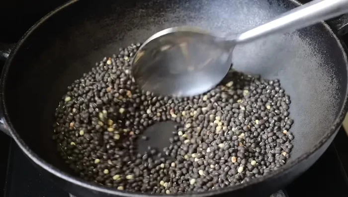 Add the urad dal paste and stir constantly until it thickens.