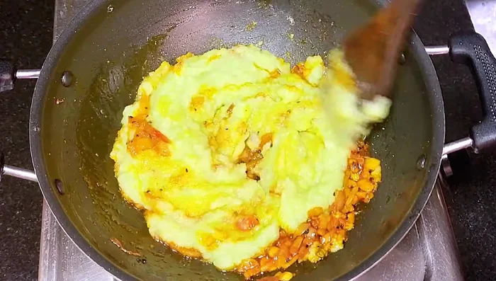 Add the cabbage paste and stir continuously on high flame until the extra water dries up and the stuffing becomes sticky. (This will take about 3-4 minutes).