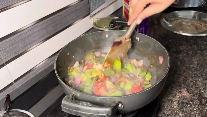 Thicken the gravy with a cornstarch slurry (cornstarch mixed with water) and cook until desired consistency is achieved.