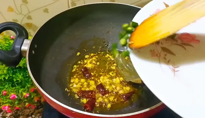 Add chopped green chilies and fry briefly.