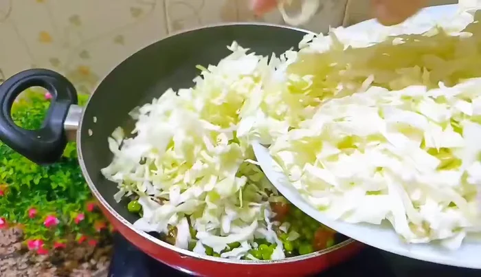 Add chopped cabbage and stir well. Increase the flame to medium-high and continue to stir until the cabbage is cooked and the quantity is reduced by half.