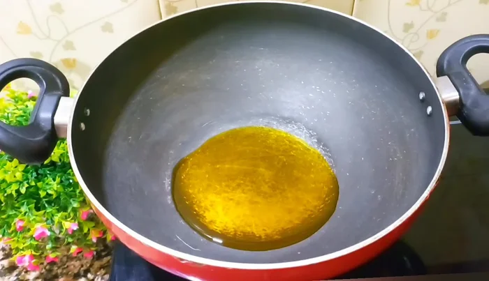 Heat mustard oil in a pan. Add cumin seeds, nigella seeds, fennel seeds, and fenugreek seeds. Stir well.