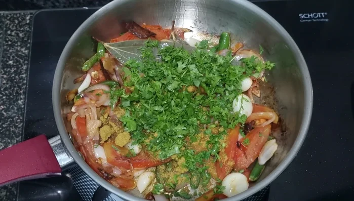Turn off the heat. Add coriander powder and coriander leaves. Blend the onion and tomato mixture in a mixer until smooth.