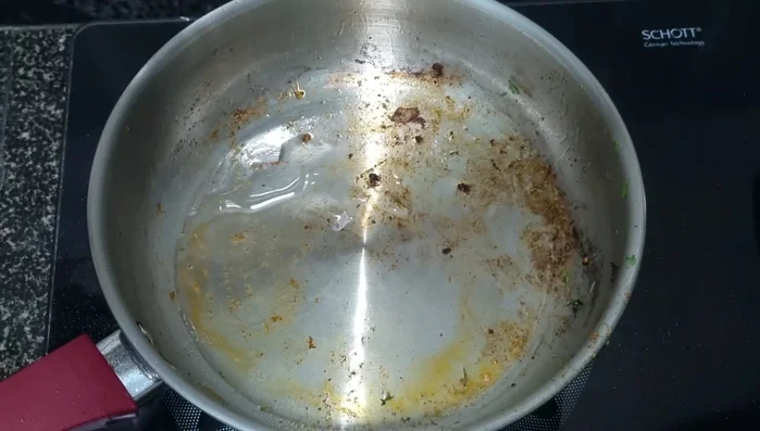 Heat oil in the same pan. Add the ground spice mixture and fry for a few minutes.
