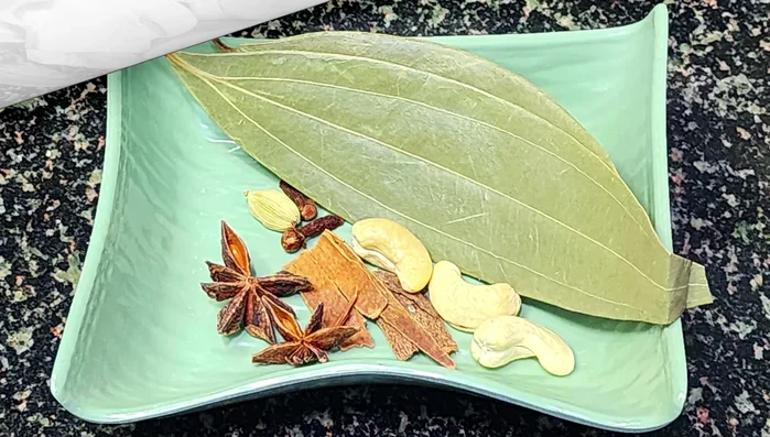 Prepare the spice blend: Combine pineapple flowers, palau leaves, cashews, cloves, and cardamoms in a bowl.
